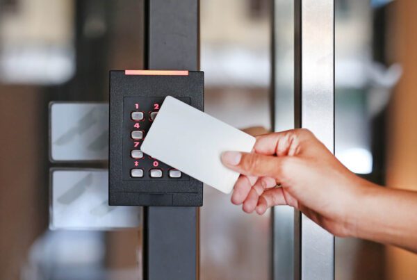 Door access control - young woman holding a key card to lock and unlock door