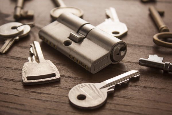 Door lock with keys on wooden surface